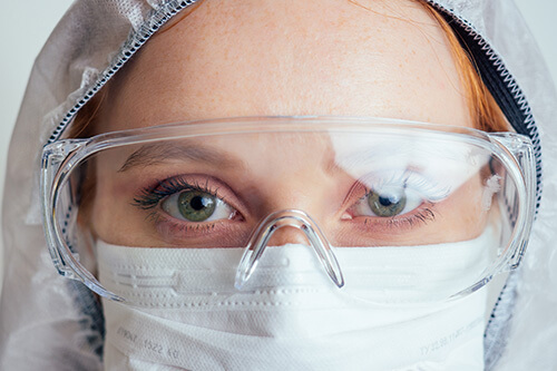 A woman wearing safety glasses to protect her eyes.
